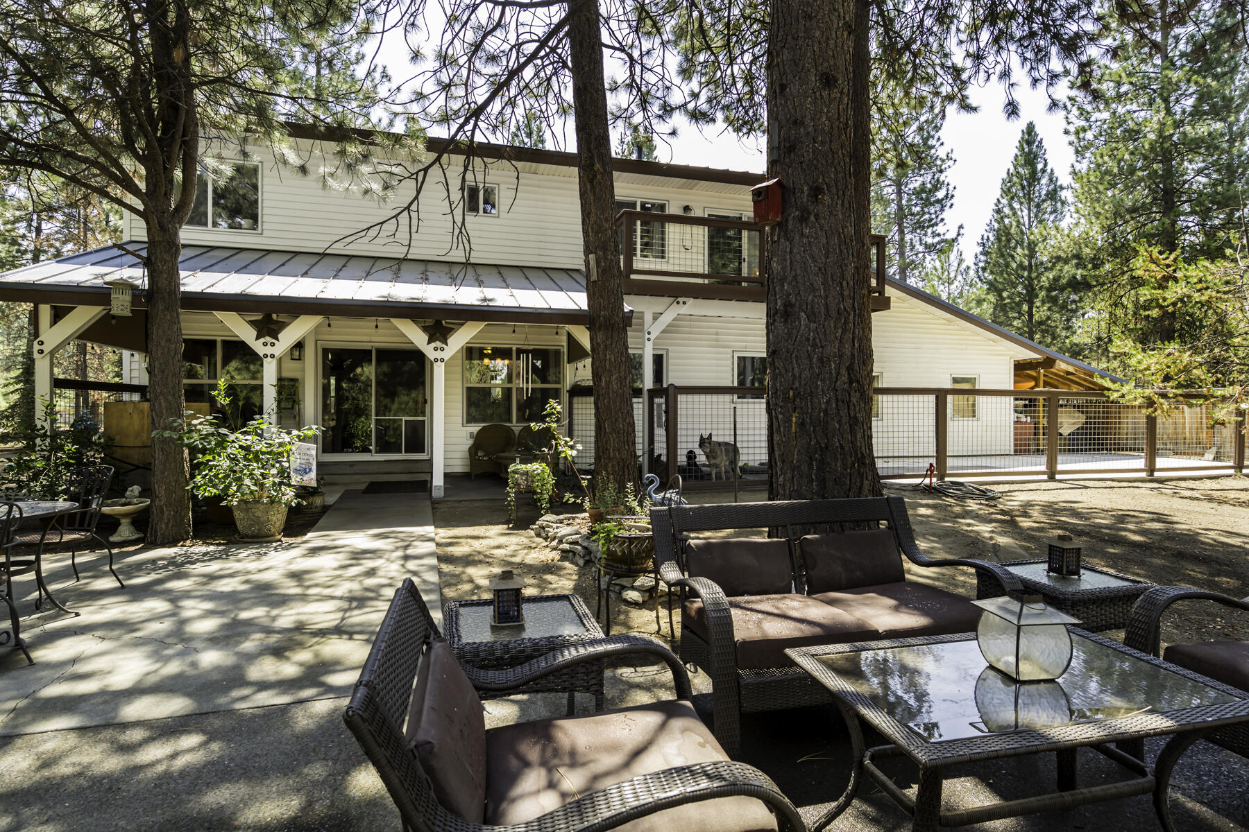 15730 Jackpine Road La Pine, OR 97739 - Photo 35 of 43 a view of a patio with table and chairs with wooden fence and floor