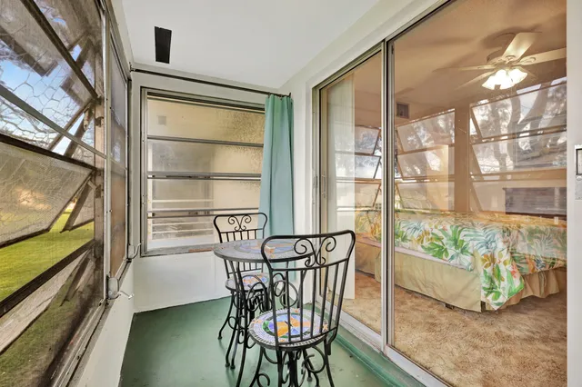 a view of a chairs and table in the balcony