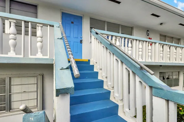 a view of entryway with wooden floor and front door