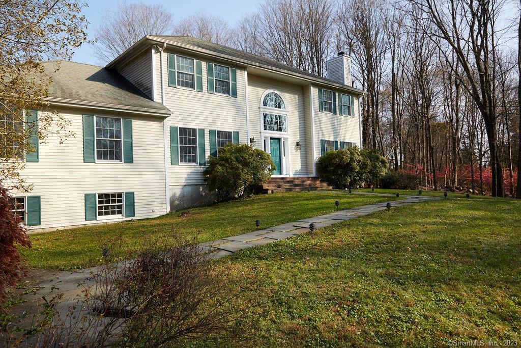 69 Old Farm Road Weston, CT 06883 - Photo 1 of 1 a front view of a house with a yard
