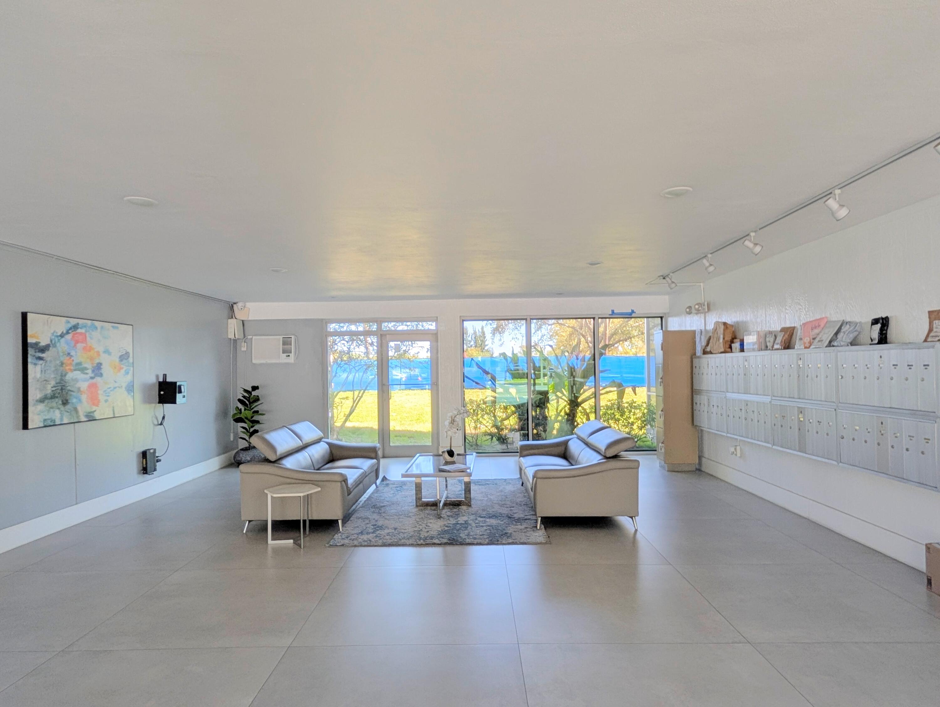 5700 Northwest 2nd Avenue, Unit 509 Boca Raton, FL 33487 - Photo 19 of 20 a living room with furniture and a large window
