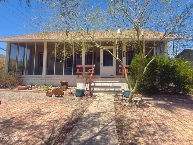 a view of a house with backyard porch and sitting area