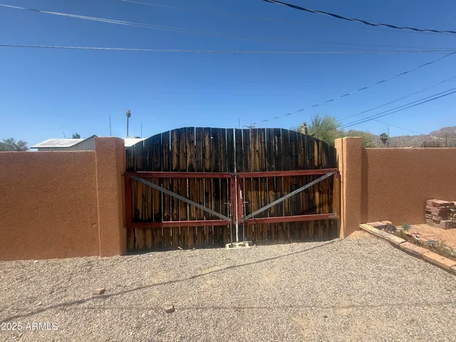 a view of a house with a wooden fence