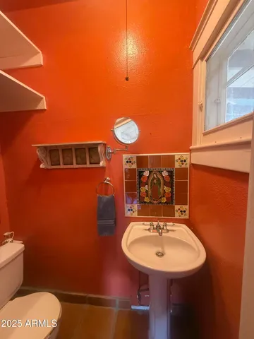 a bathroom with a sink a mirror and a toilet