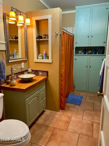 a bathroom with a sink a toilet and mirror