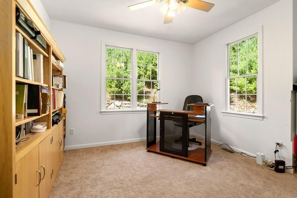 300 Crownshield Avenue Uxbridge, MA 01569 - Photo 12 of 29 a view of a workspace with furniture and a window