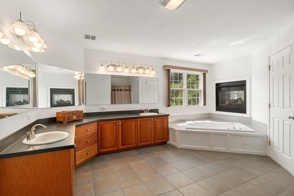 300 Crownshield Avenue Uxbridge, MA 01569 - Photo 15 of 29 a spacious bathroom with a granite countertop tub and a sink