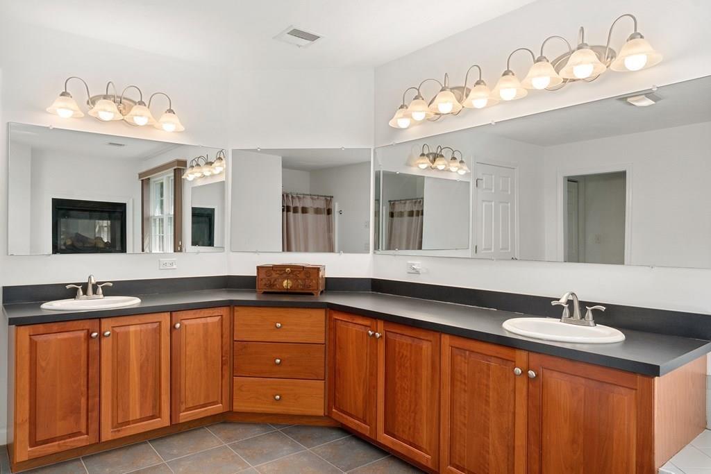 300 Crownshield Avenue Uxbridge, MA 01569 - Photo 16 of 29 a bathroom with double vanity and a mirror