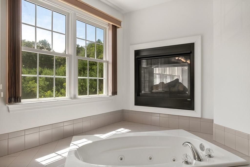 300 Crownshield Avenue Uxbridge, MA 01569 - Photo 17 of 29 a bathroom with a bathtub and a window