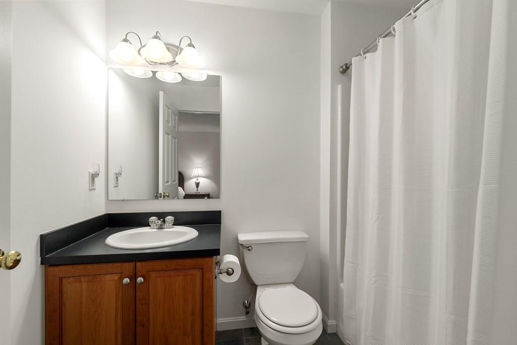 300 Crownshield Avenue Uxbridge, MA 01569 - Photo 20 of 29 a bathroom with a sink a toilet and mirror
