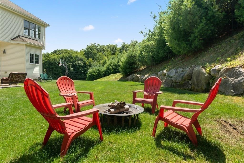 300 Crownshield Avenue Uxbridge, MA 01569 - Photo 28 of 29 a backyard of a house with outdoor seating