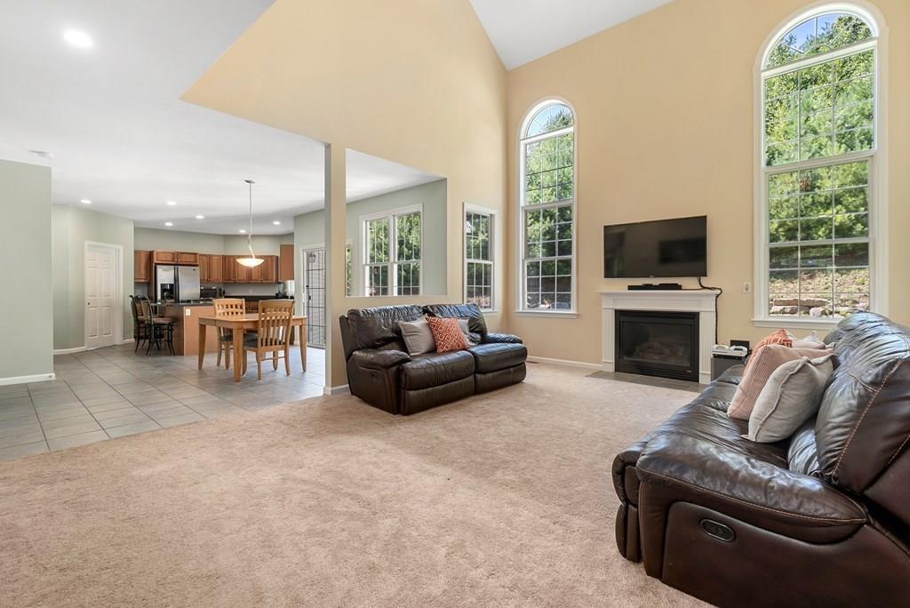 300 Crownshield Avenue Uxbridge, MA 01569 - Photo 4 of 29 a living room with furniture fireplace and flat screen tv