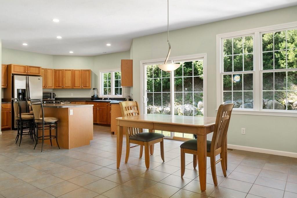 300 Crownshield Avenue Uxbridge, MA 01569 - Photo 6 of 29 a dining area with stainless steel appliances a table and chairs