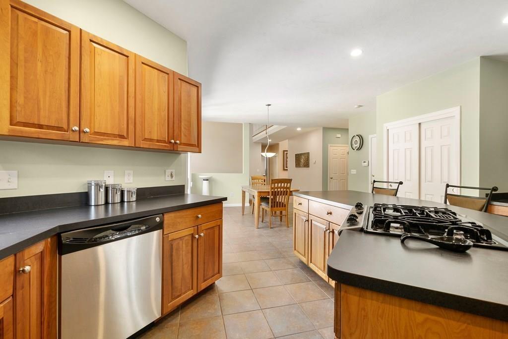 300 Crownshield Avenue Uxbridge, MA 01569 - Photo 8 of 29 a kitchen with stainless steel appliances a sink stove and cabinets