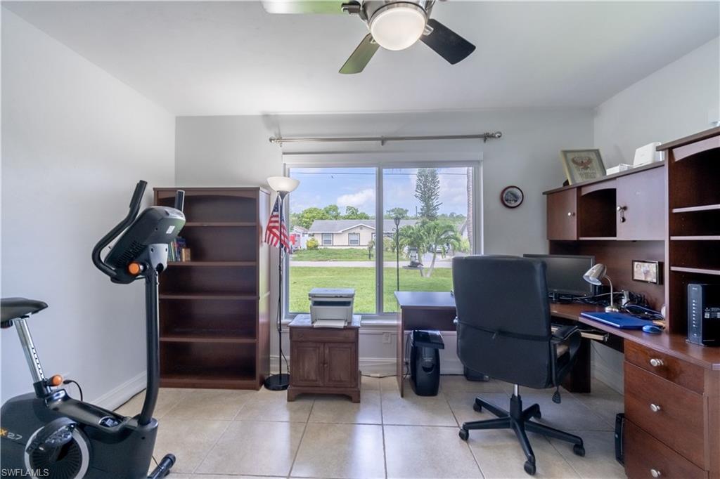 2100 55th Street Southwest Naples, FL 34116 - Photo 38 of 50 a view of a workspace with furniture and a window