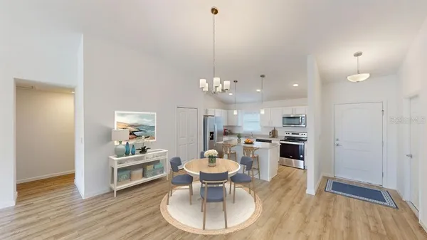 a dining room with furniture and wooden floor