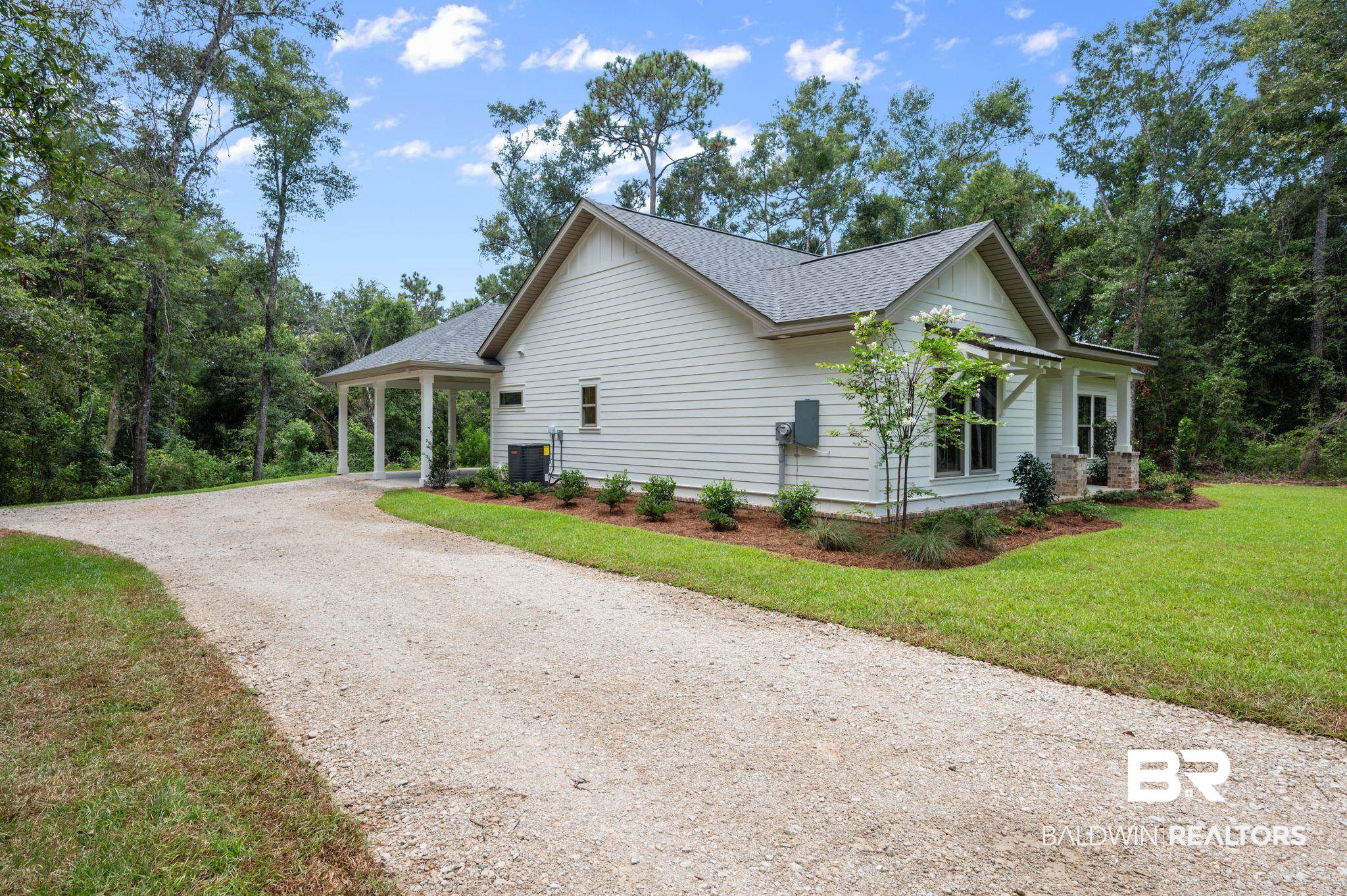 12412 Mannich Lane Foley, AL 36535 - Photo 3 of 23 View of home's exterior featuring central AC unit and a yard