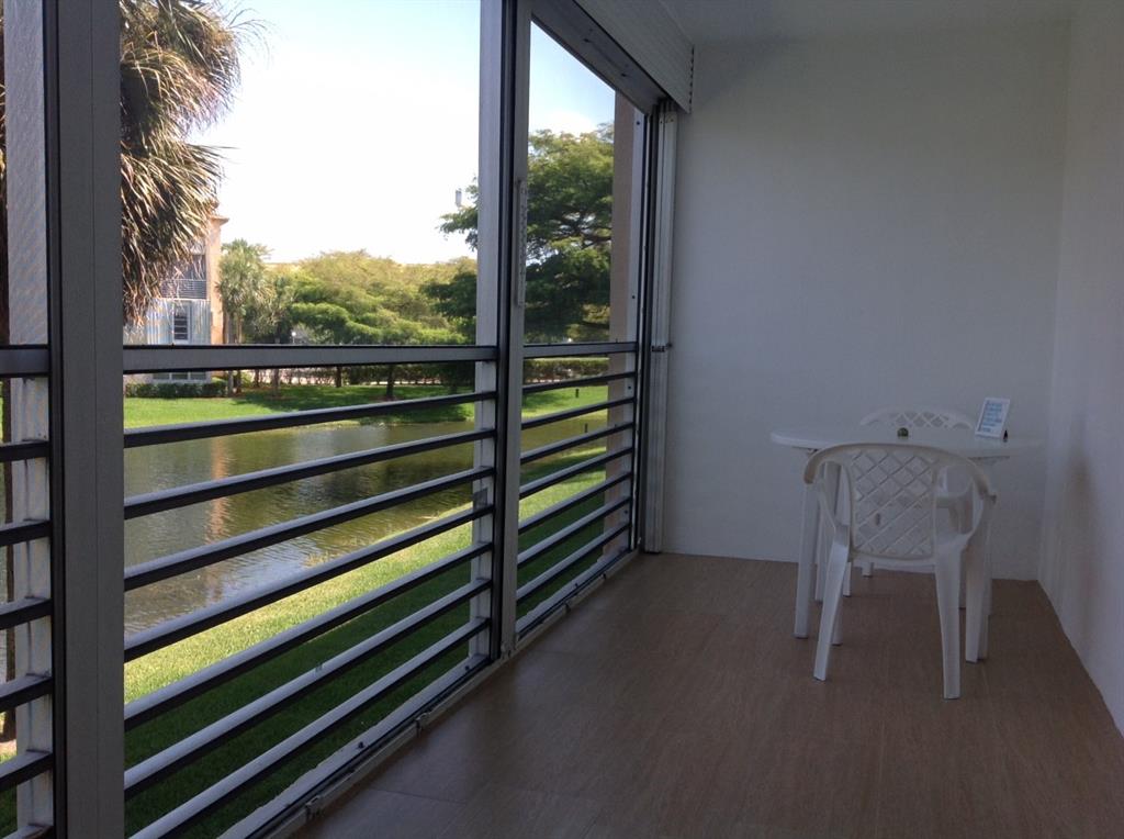 1805 Eleuthera Point, Unit J2 Coconut Creek, FL 33066 - Photo 11 of 22 a view of a two chair in the room and window