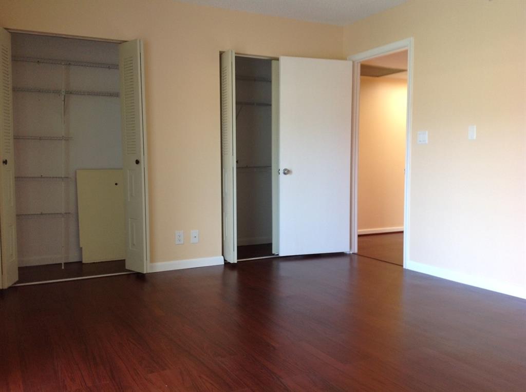 1805 Eleuthera Point, Unit J2 Coconut Creek, FL 33066 - Photo 16 of 22 an empty room with wooden floor and closet