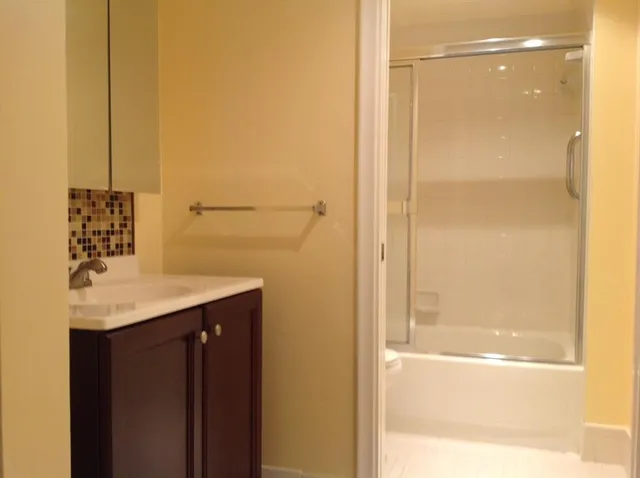 a bathroom with a shower and a sink