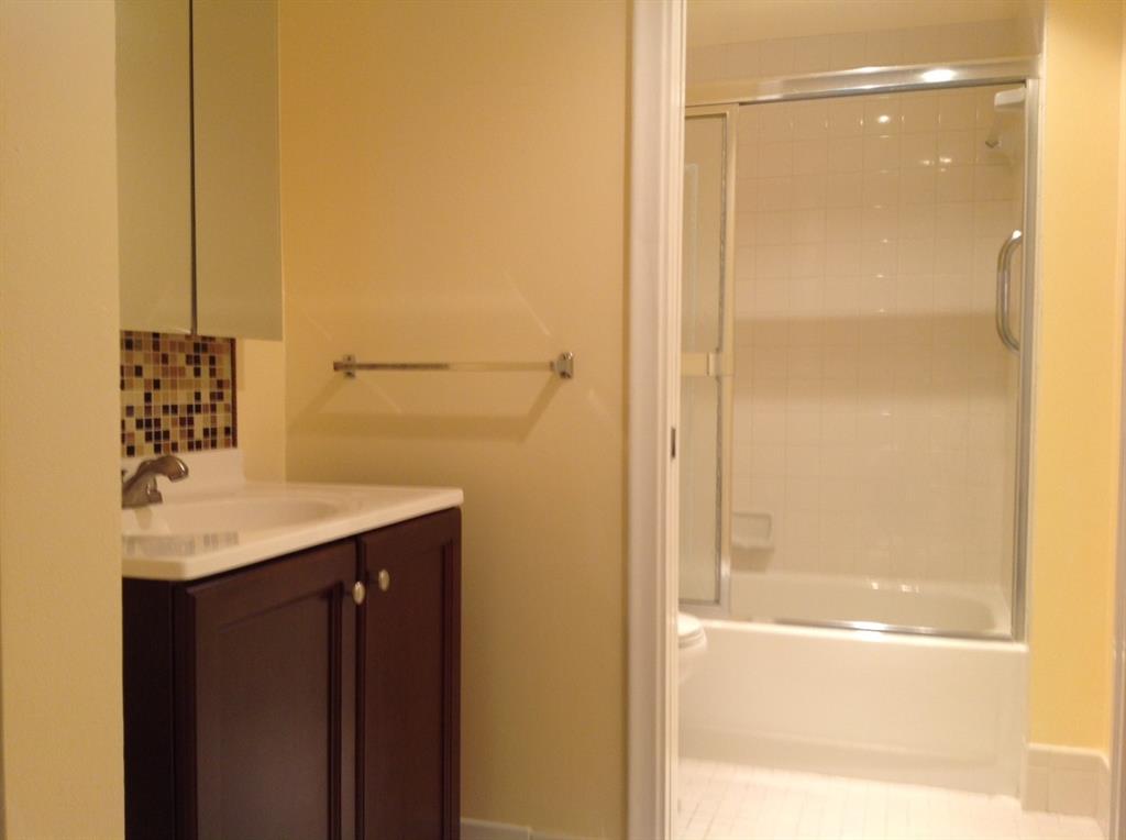 1805 Eleuthera Point, Unit J2 Coconut Creek, FL 33066 - Photo 18 of 22 a bathroom with a shower and a sink