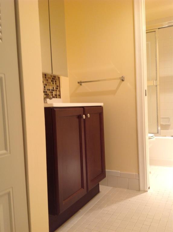 1805 Eleuthera Point, Unit J2 Coconut Creek, FL 33066 - Photo 19 of 22 a bathroom with a sink and a mirror