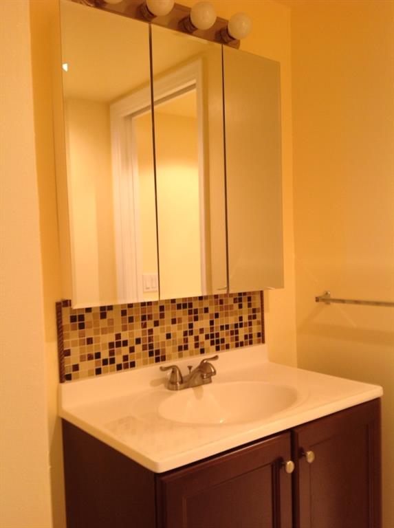 1805 Eleuthera Point, Unit J2 Coconut Creek, FL 33066 - Photo 21 of 22 a bathroom with a sink and a mirror