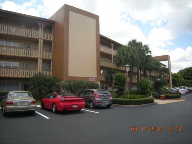 1805 Eleuthera Point, Unit J2 Coconut Creek, FL 33066 - Photo 22 of 22 a car parked in front of a building