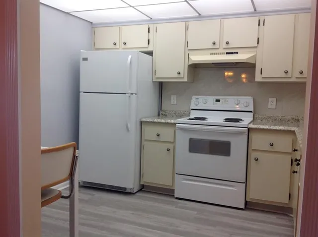 a kitchen with a white cabinets and white appliances