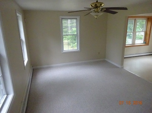 8 Mayflower Lane Rochester, MA 02770 - Photo 4 of 19 an empty room with windows and fan