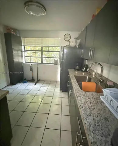 a bathroom with a granite countertop sink a toilet and mirror