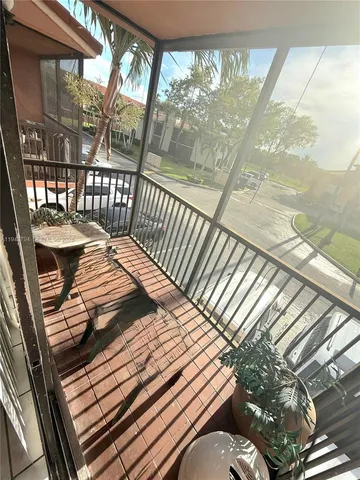 a view of a balcony with wooden floor