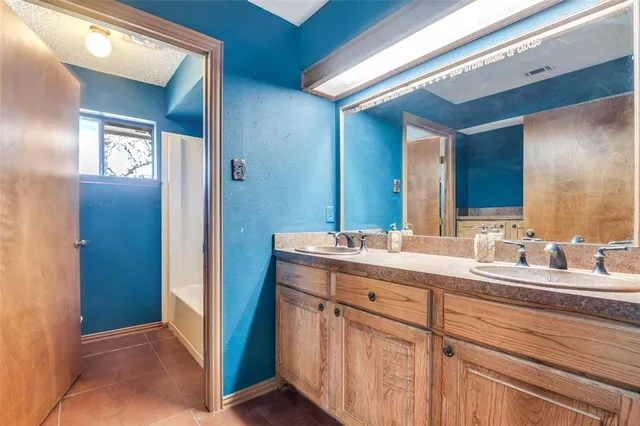 a bathroom with a double vanity sink and mirror