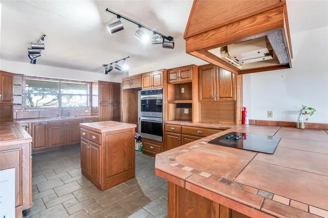 a kitchen that has a sink and a stove
