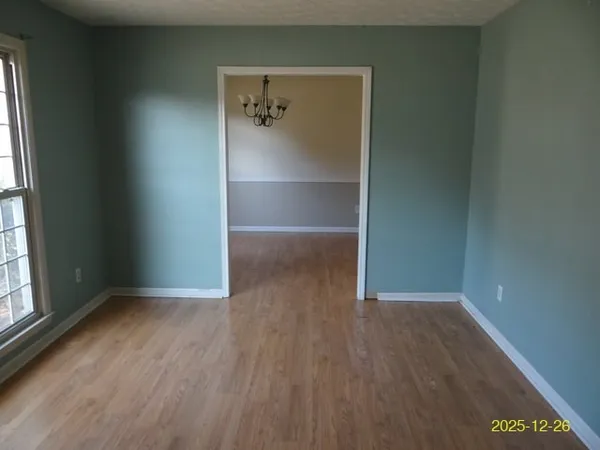 a view of a room with racks on the wall and a window