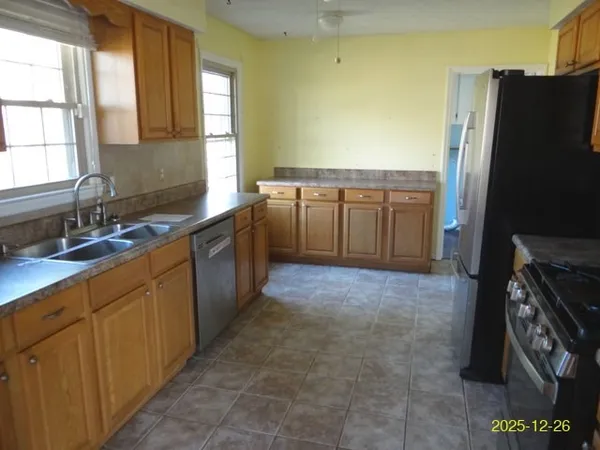 a kitchen with a stove a sink and a refrigerator