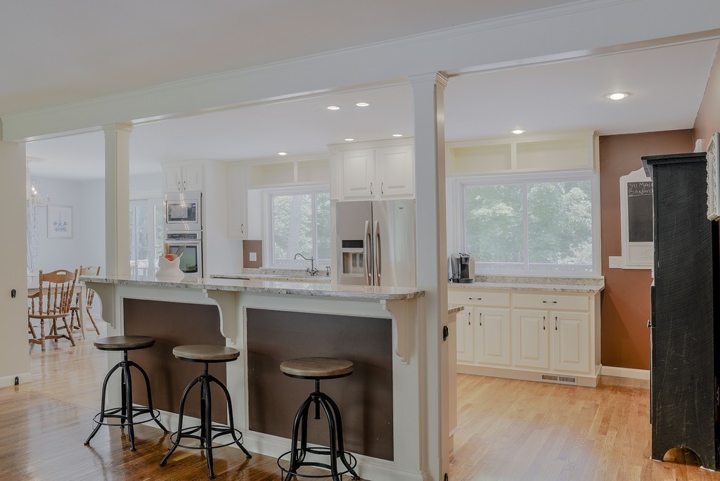 341 Main Street Boxford, MA 01921 - Photo 12 of 30 a kitchen with granite countertop white cabinets and chairs
