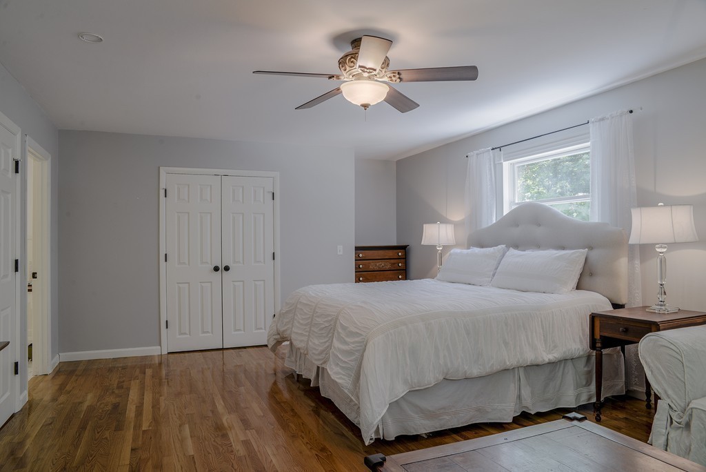 341 Main Street Boxford, MA 01921 - Photo 17 of 30 a bedroom with a bed and a chandelier