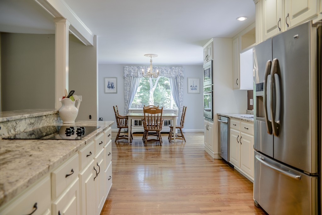 341 Main Street Boxford, MA 01921 - Photo 7 of 30 a kitchen with stainless steel appliances granite countertop a dining table chairs stove refrigerator and cabinets