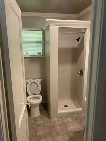 a bathroom with a toilet and a shower