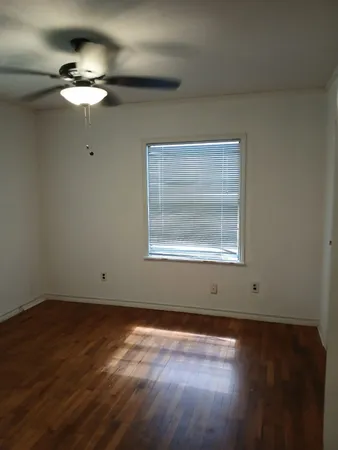 a view of wooden floor and windows in a room