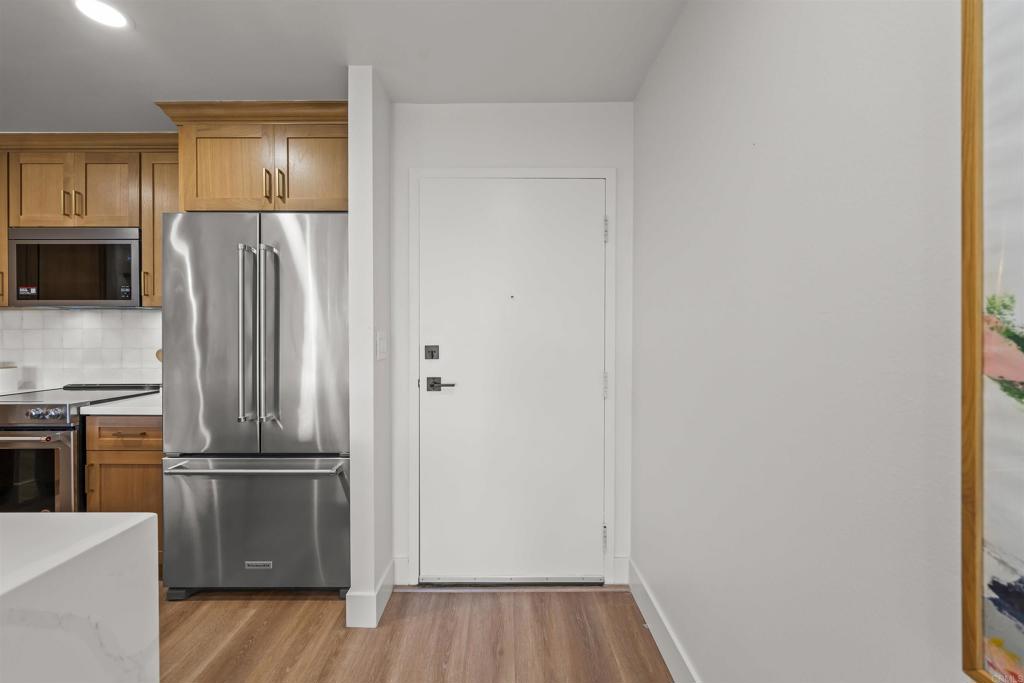 2500 Torrey Pines Road, Unit 305 La Jolla, CA 92037 - Photo 12 of 48 a kitchen with a refrigerator and a stove top oven