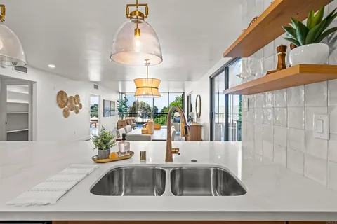 a stove top oven sitting inside of a kitchen