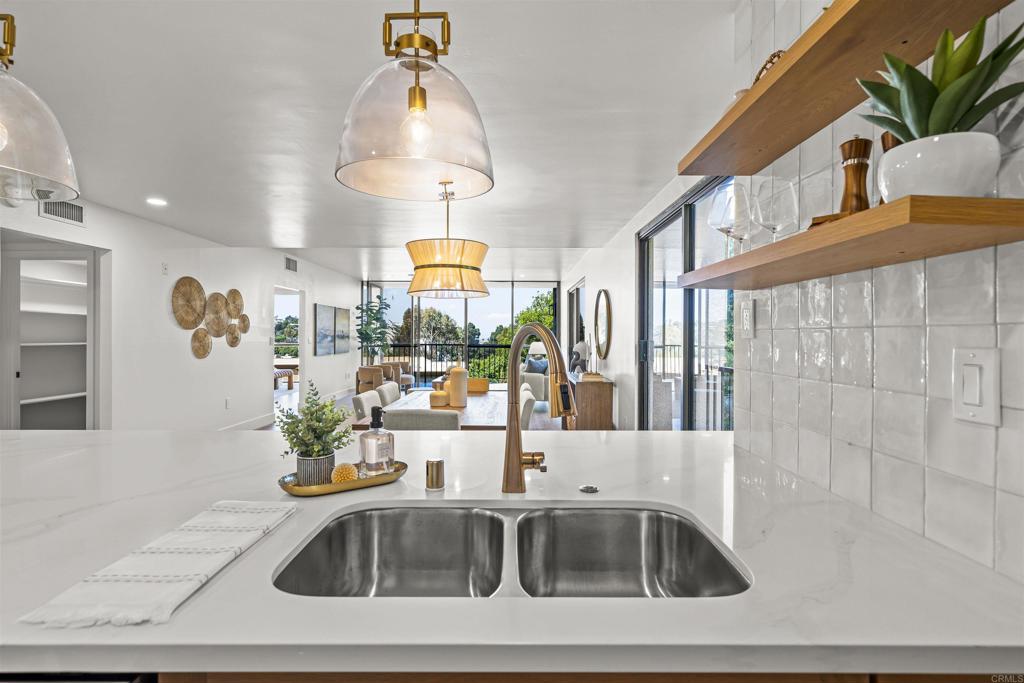 2500 Torrey Pines Road, Unit 305 La Jolla, CA 92037 - Photo 14 of 48 a kitchen with a sink a counter and cabinets