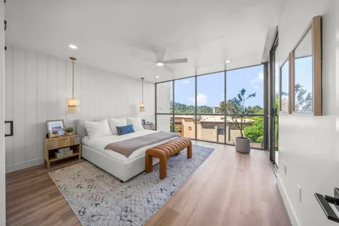 a bedroom with a large bed and a large window