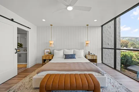 a bedroom with a bed and a chandelier