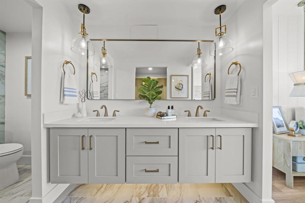 2500 Torrey Pines Road, Unit 305 La Jolla, CA 92037 - Photo 31 of 48 a spacious bathroom with a double vanity sink mirror and toilet