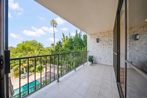 a view of a balcony with lake view and a potted plant