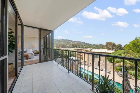 a view of a house with pool and chairs