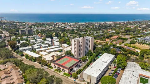 an aerial view of a residential apartment building with a yard